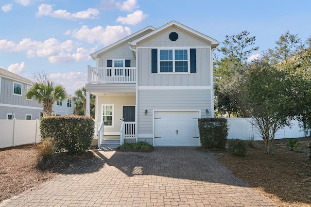 view of front property with a garage and a balcony