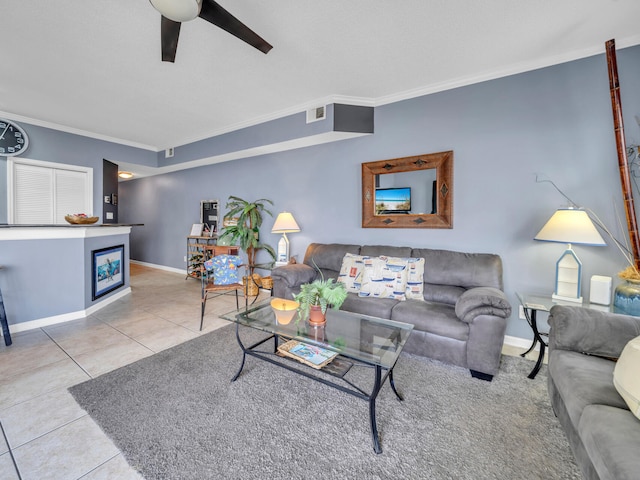 living room with visible vents, ornamental molding, a ceiling fan, tile patterned flooring, and baseboards