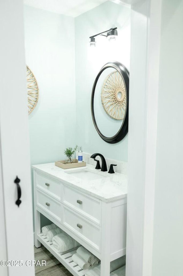 bathroom with vanity and hardwood / wood-style floors