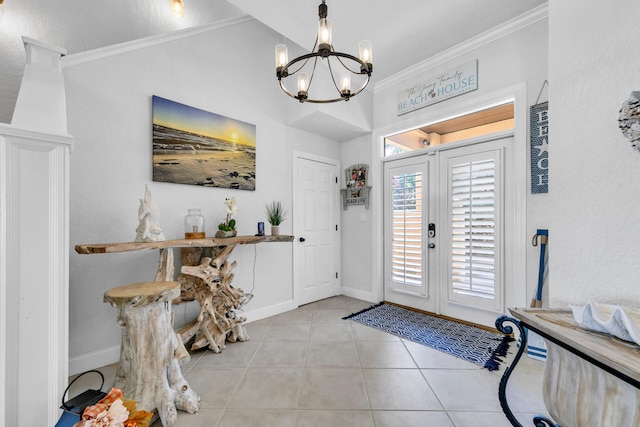 tiled foyer entrance with baseboards, a chandelier, crown molding, and french doors