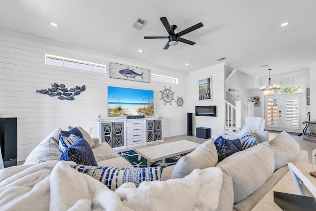 living room featuring stairs, ornamental molding, visible vents, and recessed lighting