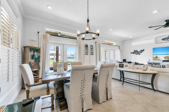 dining area featuring light tile patterned floors, a textured ceiling, crown molding, and french doors