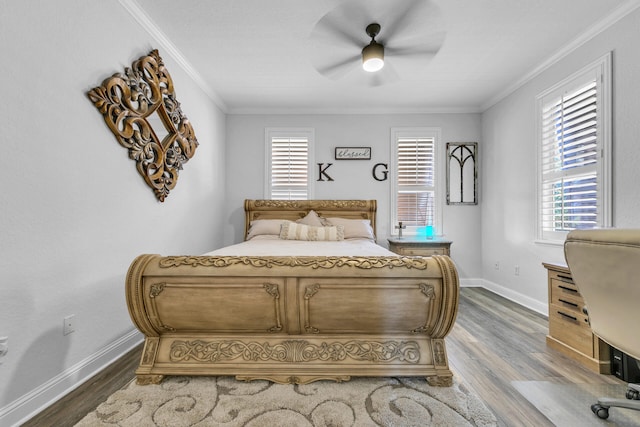 bedroom with multiple windows, crown molding, and wood finished floors