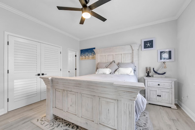 bedroom featuring baseboards, ornamental molding, and light wood-style floors