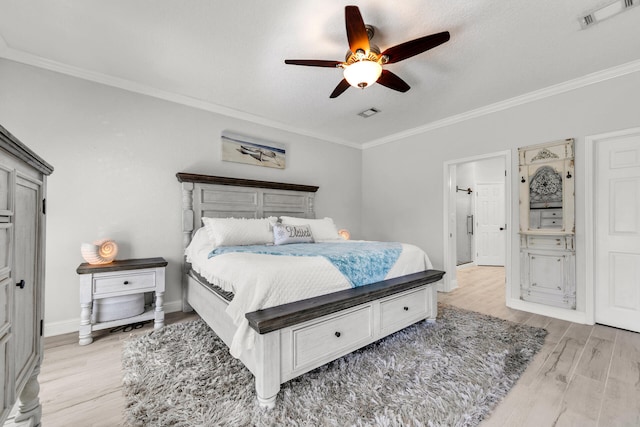 bedroom with baseboards, visible vents, ceiling fan, ornamental molding, and light wood-style floors