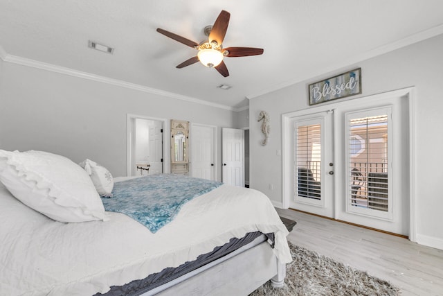 bedroom featuring wood finished floors, visible vents, baseboards, access to outside, and ornamental molding