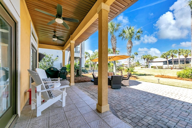 view of patio / terrace with a grill, outdoor dining area, and a ceiling fan