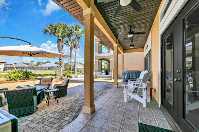 view of patio with ceiling fan, outdoor lounge area, and fence