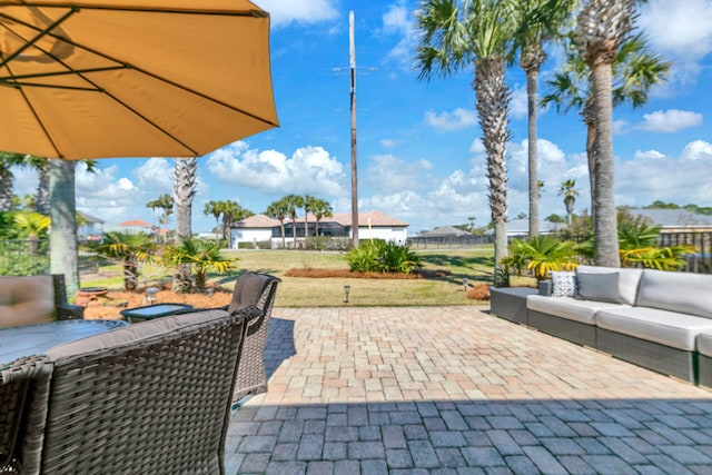 view of patio / terrace featuring outdoor lounge area and fence