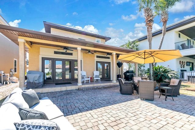 exterior space with ceiling fan, french doors, outdoor dining space, and a grill