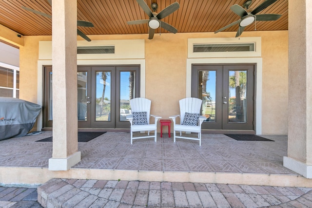 doorway to property featuring ceiling fan, french doors, and stucco siding