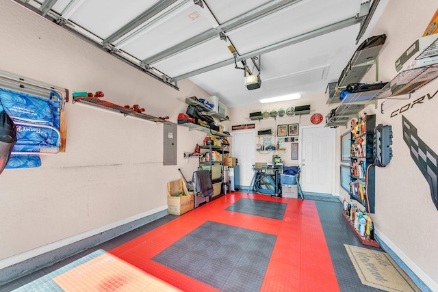 garage with a garage door opener, electric panel, and baseboards