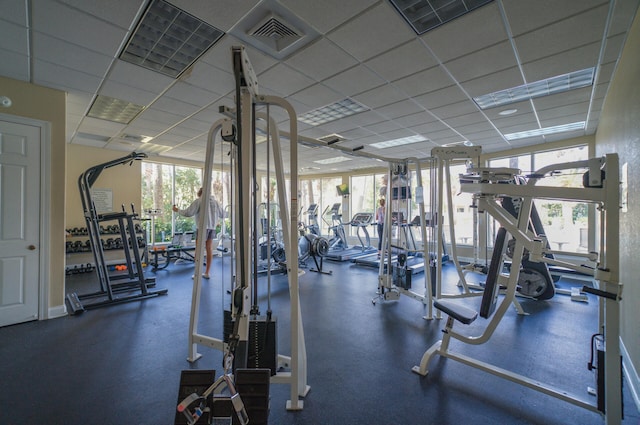 gym featuring a wealth of natural light, a drop ceiling, and visible vents