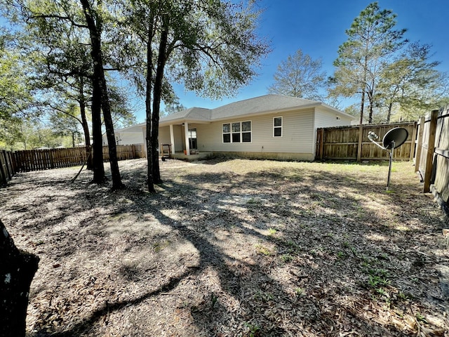 back of house featuring a fenced backyard