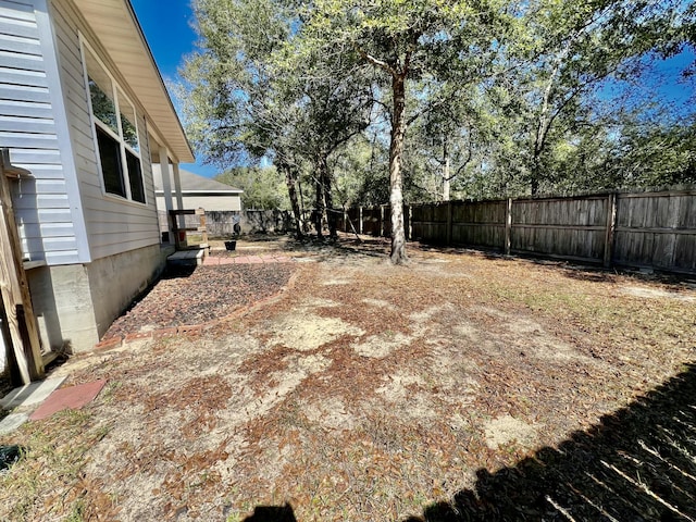 view of yard with a fenced backyard