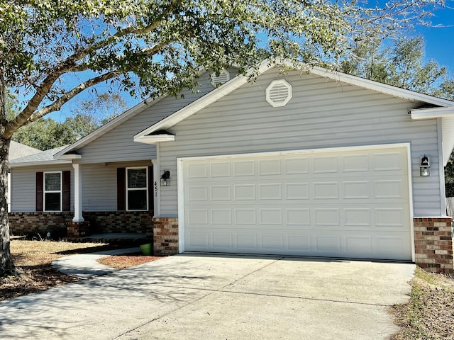 single story home with a garage, brick siding, and driveway