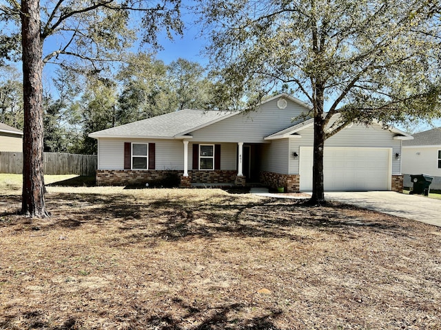 ranch-style house featuring an attached garage, fence, concrete driveway, and brick siding