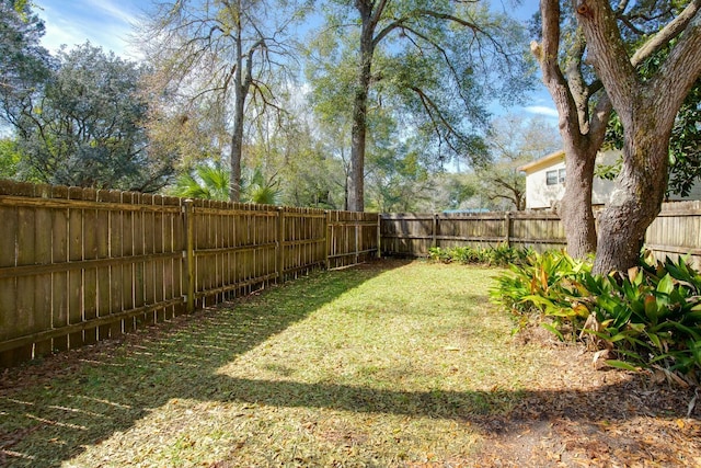 view of yard with a fenced backyard