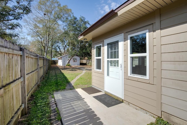 exterior space featuring a fenced backyard and an outdoor structure