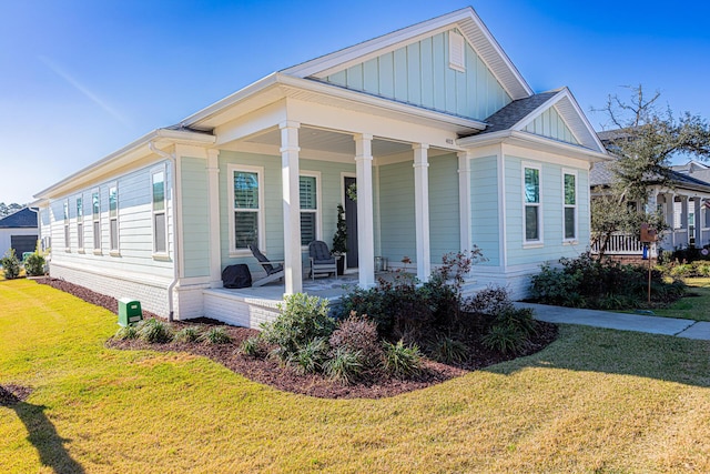 view of front of property with a front yard and a porch