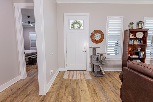 entryway featuring light wood-type flooring and ceiling fan