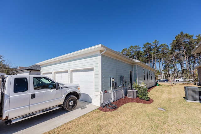 view of side of home with central AC unit and a yard