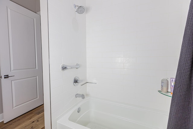 bathroom featuring shower / bath combo with shower curtain and wood-type flooring