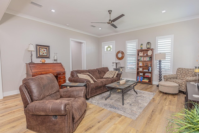 living room with ceiling fan, ornamental molding, and light wood-type flooring