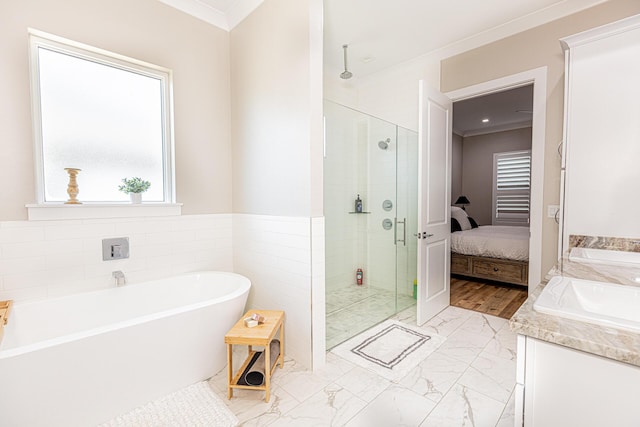 bathroom featuring sink, tile walls, plus walk in shower, and crown molding