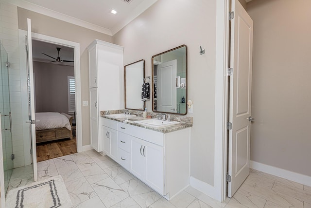 bathroom with ceiling fan, vanity, crown molding, and a shower with shower door