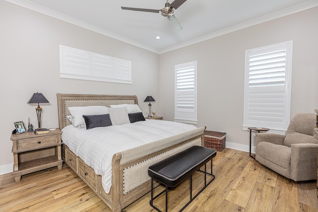 bedroom with ceiling fan, crown molding, and light hardwood / wood-style floors