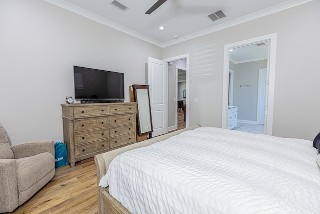 bedroom featuring ceiling fan, ornamental molding, light wood-type flooring, and connected bathroom