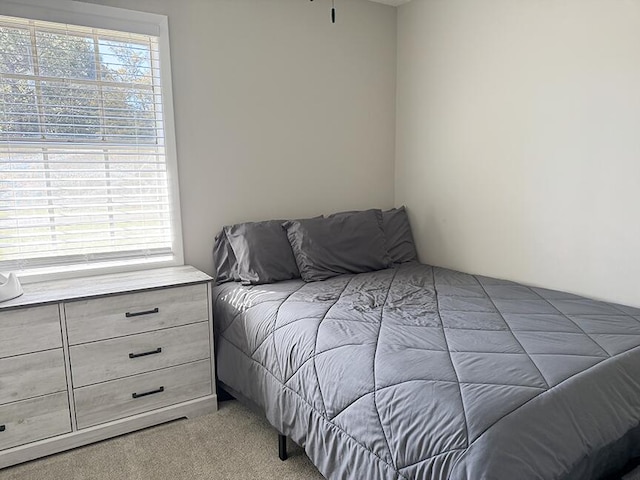 bedroom featuring light colored carpet