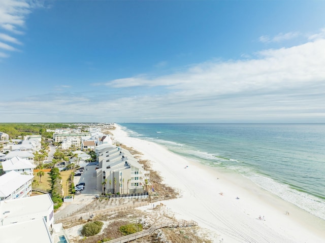 birds eye view of property featuring a water view and a beach view