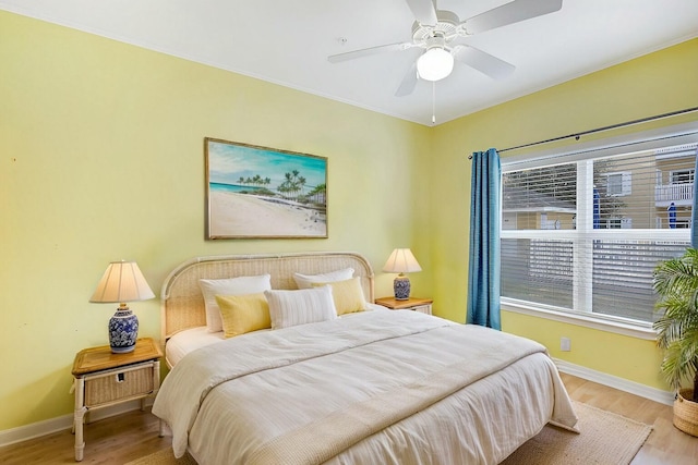 bedroom with ceiling fan and light hardwood / wood-style flooring