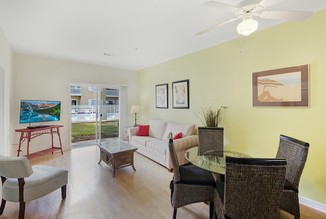 living room featuring light hardwood / wood-style floors and ceiling fan