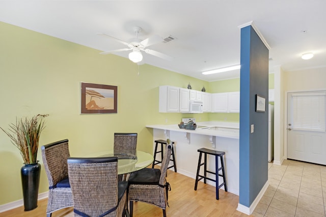 dining room featuring light hardwood / wood-style floors and ceiling fan