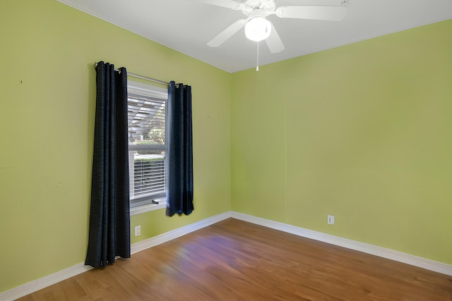 spare room featuring hardwood / wood-style floors and ceiling fan