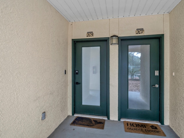 entrance to property with stucco siding