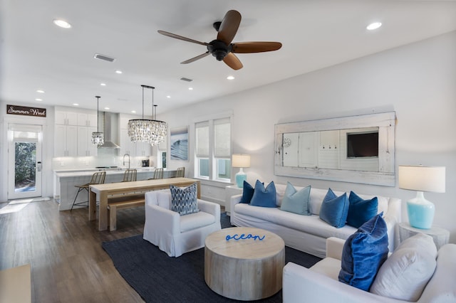 living room featuring dark wood-style floors, a wealth of natural light, visible vents, and recessed lighting