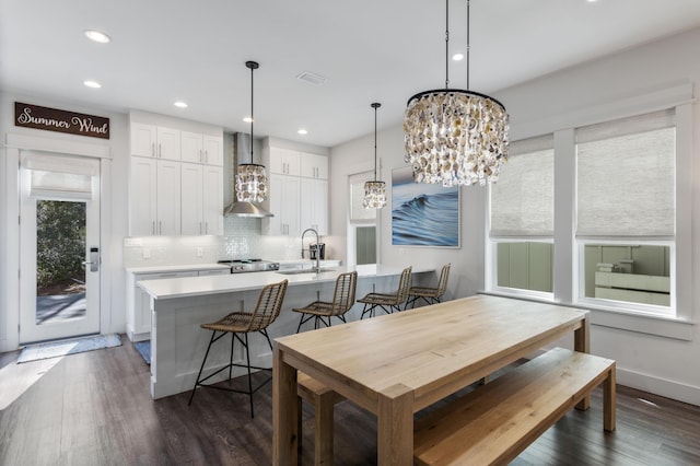 dining room with baseboards, a chandelier, dark wood-type flooring, and recessed lighting