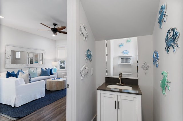 bathroom with a ceiling fan, vanity, and wood finished floors