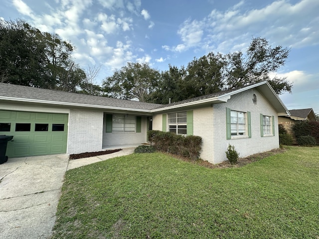 ranch-style house with a front yard and a garage