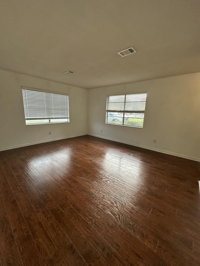 empty room featuring dark hardwood / wood-style flooring