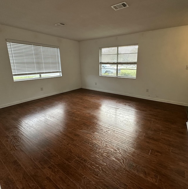 empty room with dark wood-type flooring