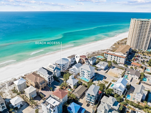 drone / aerial view with a beach view and a water view