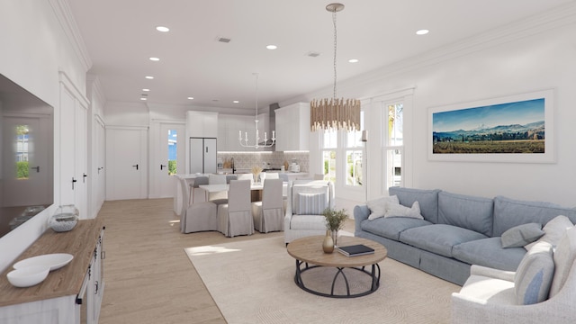 living room with crown molding, recessed lighting, visible vents, a chandelier, and light wood-type flooring