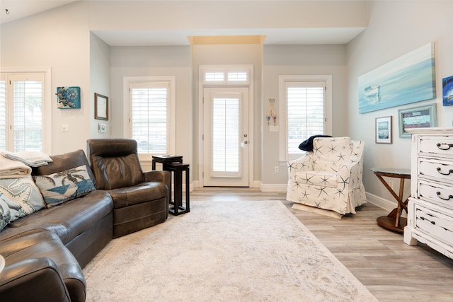 living area featuring light wood finished floors and baseboards