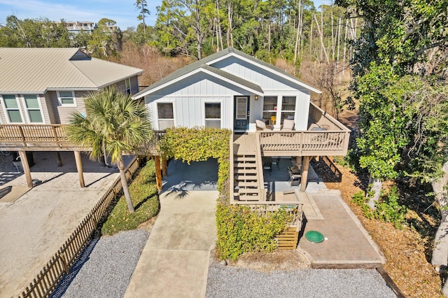 view of front facade featuring stairs, a deck, and board and batten siding