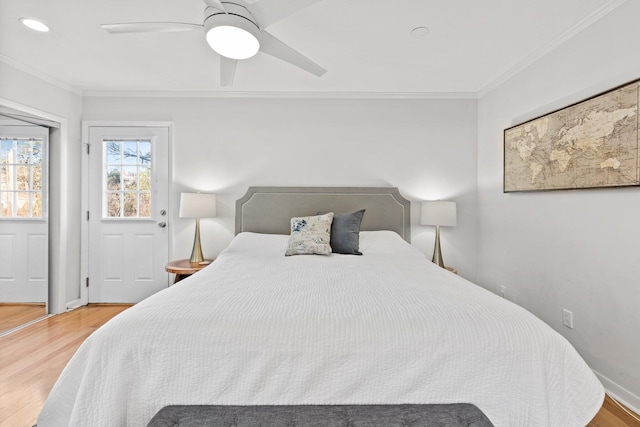 bedroom with a ceiling fan, crown molding, and wood finished floors